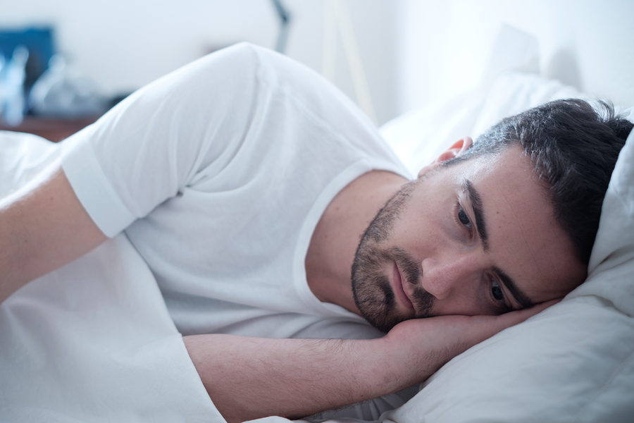 Depressed Man Lying In His Bed And Feeling Bad