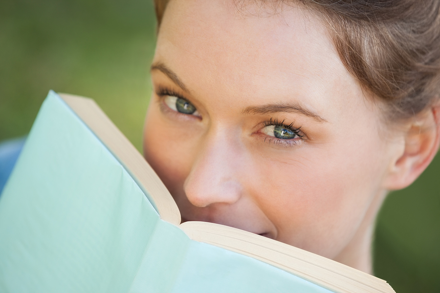 Extreme close-up portrait of a beautiful young woman with book i