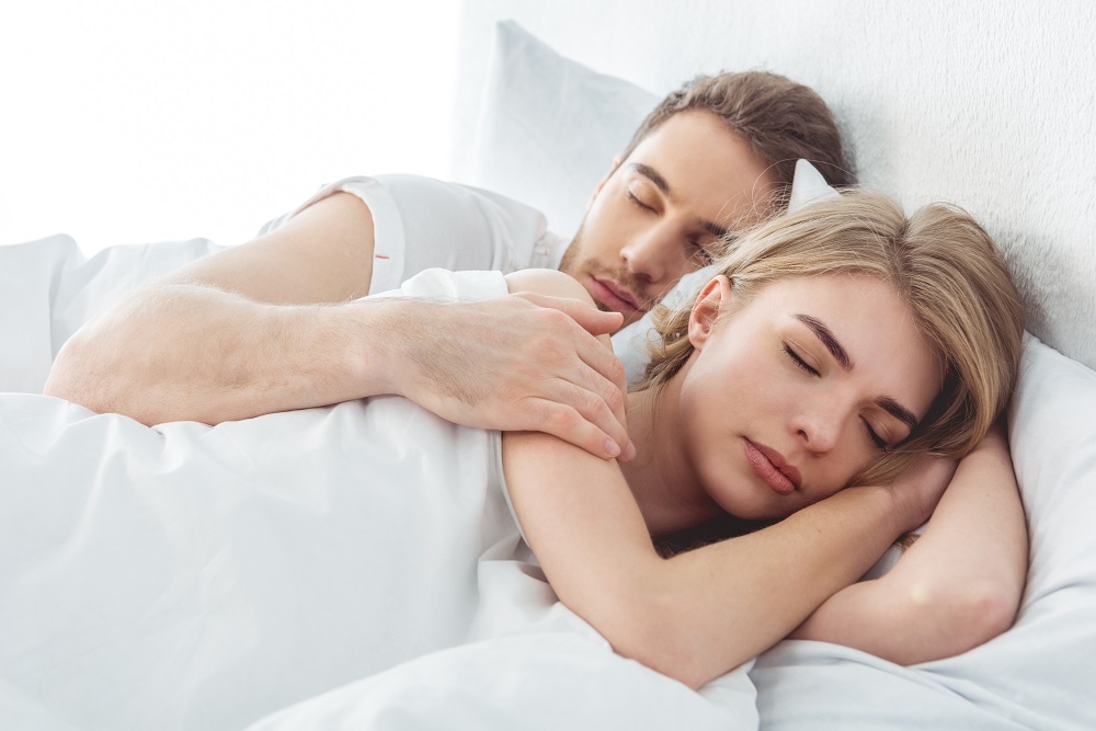 Couple Sleeping In Bed