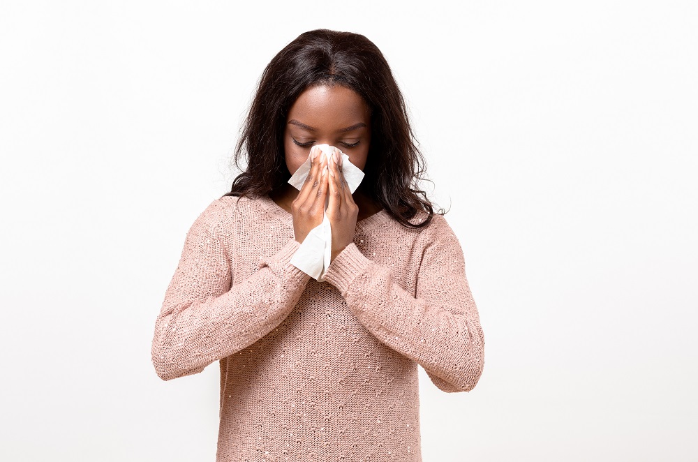 Unwell Young Woman Blowing Her Nose