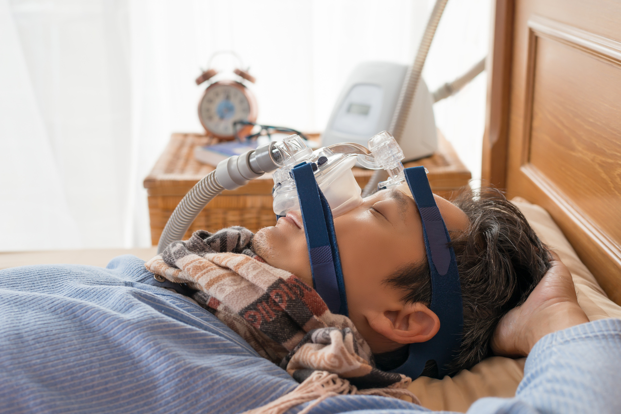 Man laying on his back wearing CPAP mask ,healthcare concept.