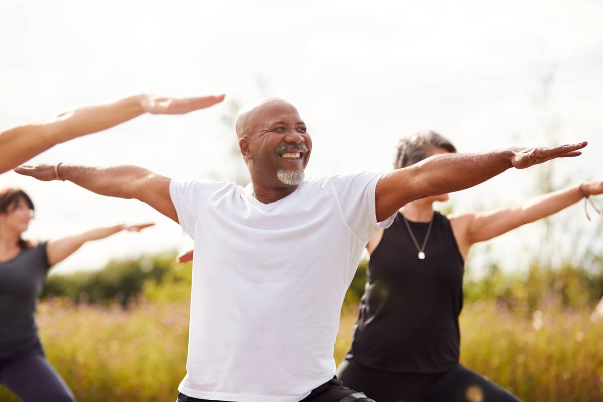 Man doing yoga exercise in a park to boost lung health.