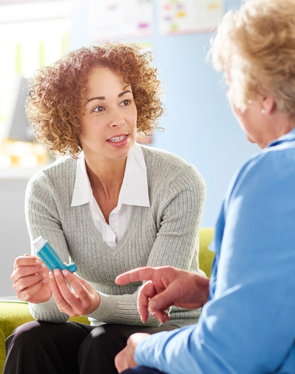 Image of office staff explaining insurance verification