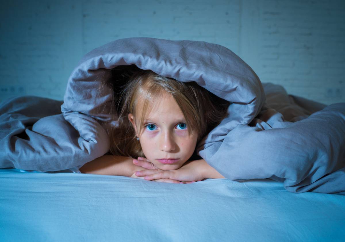 Child under blanket with a sleep disorder