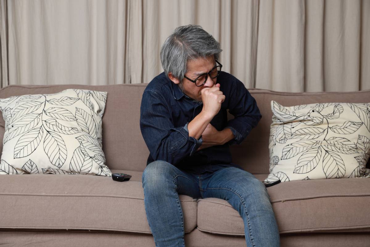 Man with asthma in old age coughing