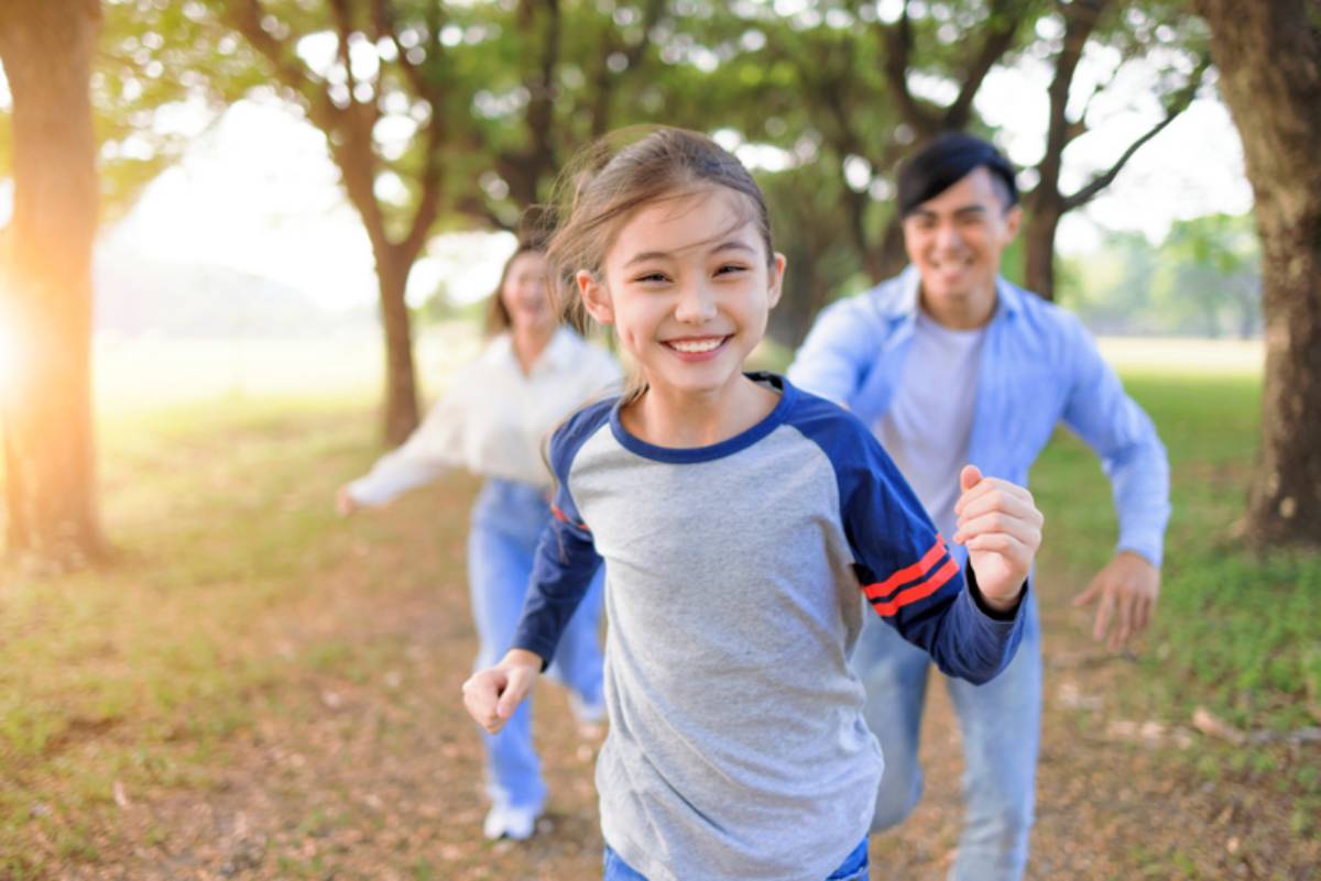 Family running and playing together in the park
